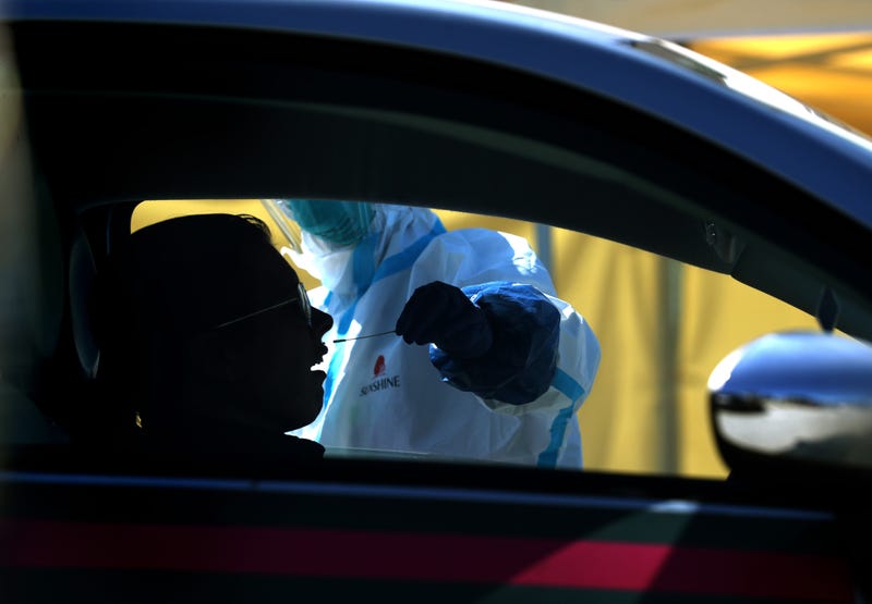 A medical professional administers a coronavirus (COVID-19) test during a drive-thru testing station on March 26, 2020 in Daly City, California.