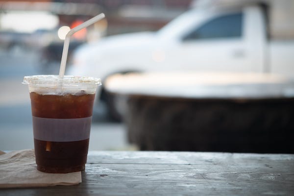 Soda in a plastic cup with a straw