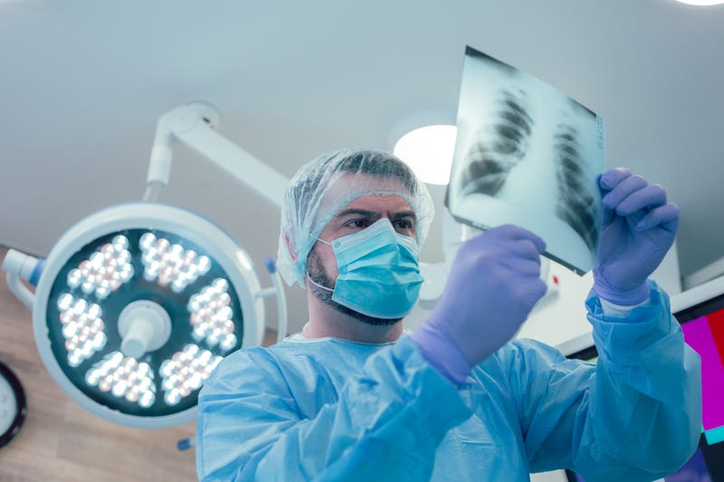 Medical professional analyzes lung scan