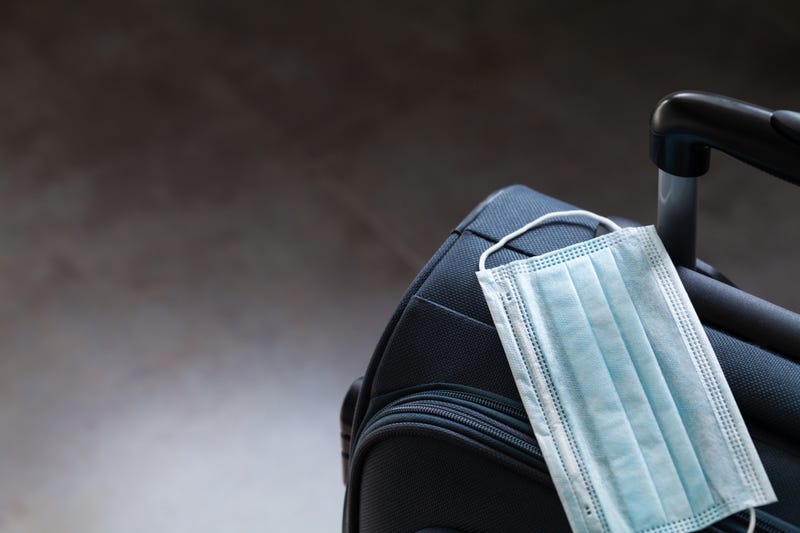 Face mask on suitcase