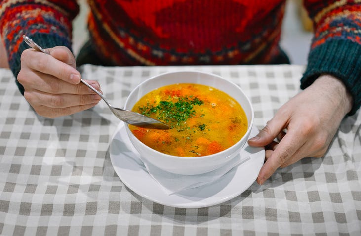 man eating soup
