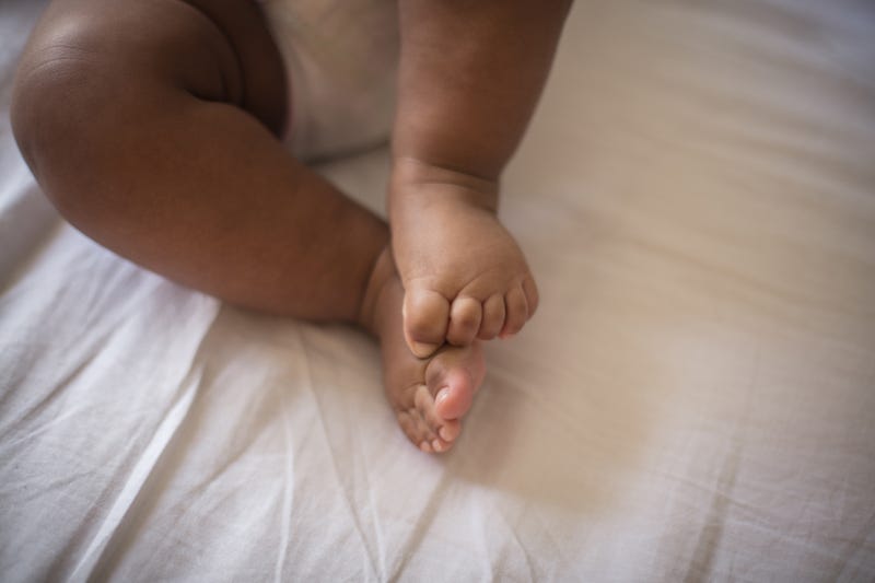 Tiny toes. - stock photo Tiny toes. Little baby on bed.