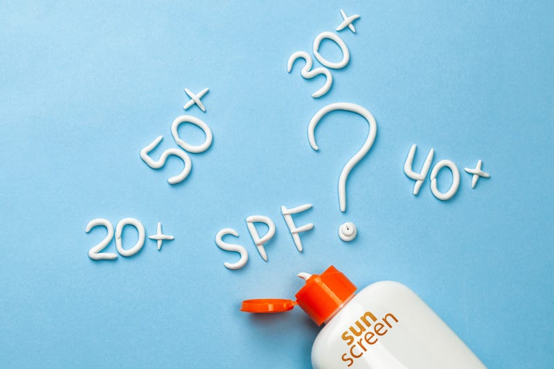Sunscreen. How to choose the degree of protection of SPF for adults and children. Cream in the form of question mark and the inscription SPF on blue background with white tube. Concept of how to choose sunblock.