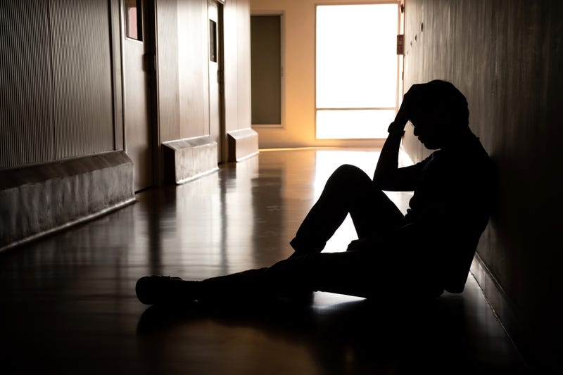 man sits in hallway