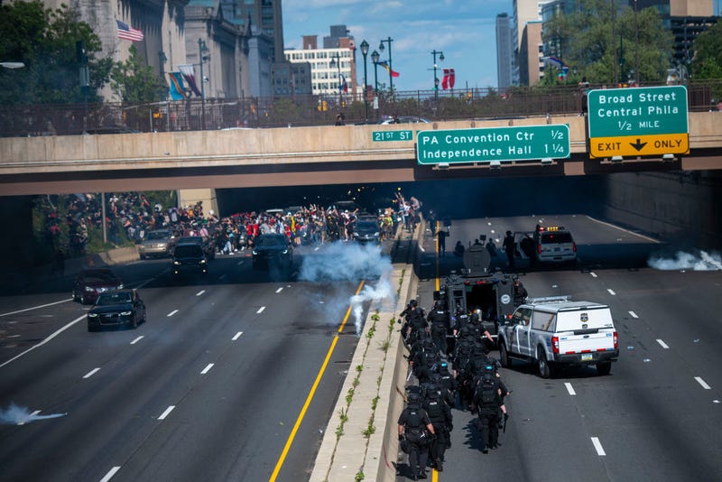 Philadelphia police officers throw and shoot tear gas into a group of protesters after a march through Center City on June 1, 2020.