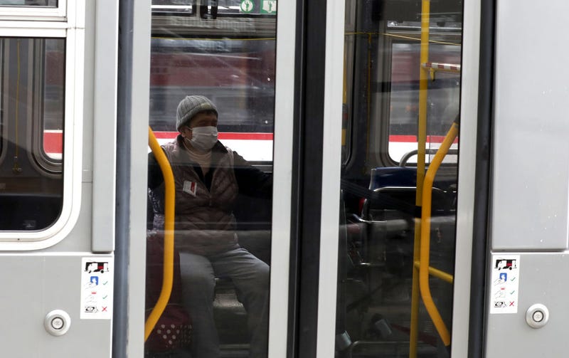A passenger wears a protective mask while riding a San Francisco MUNI bus during the coronavirus (COVID-19) pandemic on April 06, 2020 in San Francisco, California. 
