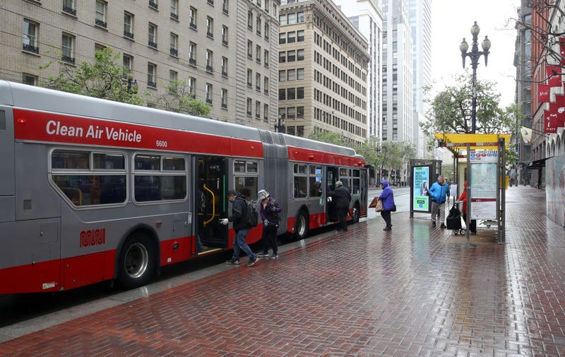 Passengers board a San Francisco MUNI bus during the coronavirus (COVID-19) pandemic on April 06, 2020 in San Francisco, California. 