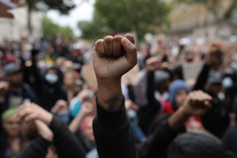 Protesters raise clenched fists during a Black Lives Matter protest outside the Houses of Parliament on June 3, 2020 in London, United Kingdom.