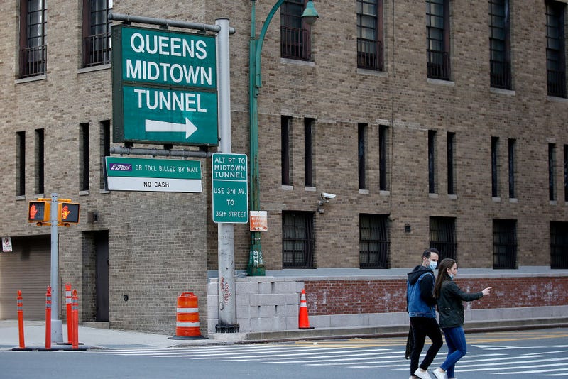 A couple cross the entrance to the Queens-Midtown Tunnel on April 7, 2020 in New York City.