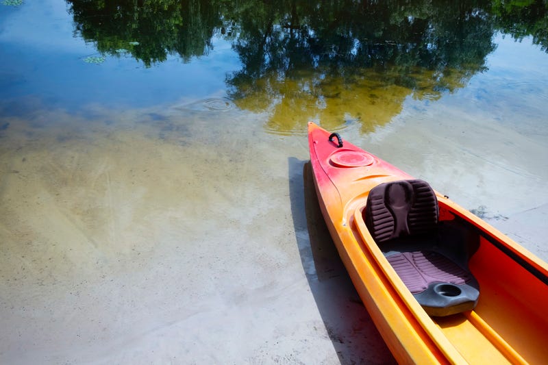 Empty kayak on shore
