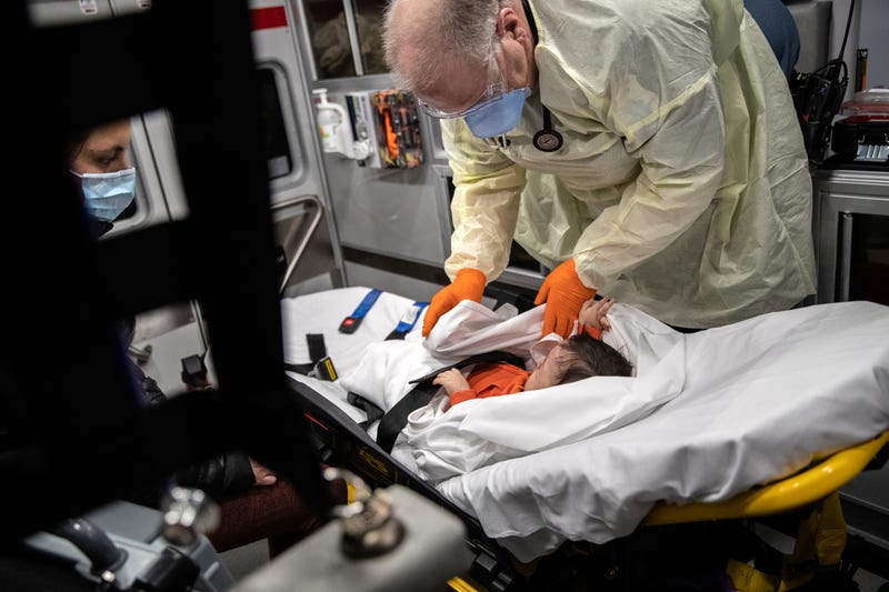Doctor checking child with COVID
