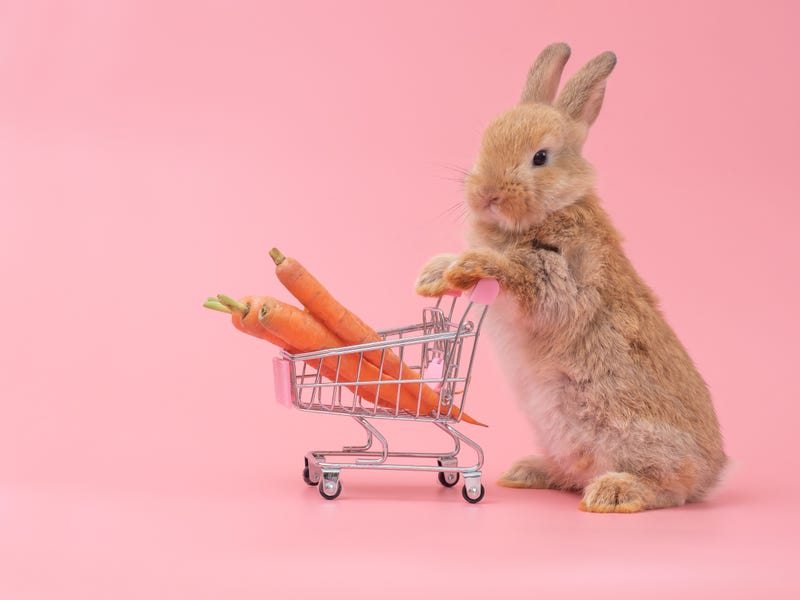 The Easter Bunny pushes a shopping cart filled with carrots