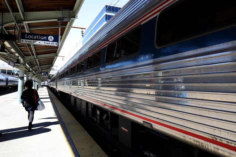 A passenger walks to a departing Amtrak train at Union Station on April 09, 2020 in Washington, D.C.