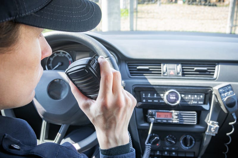 Police officer talks into CB radio