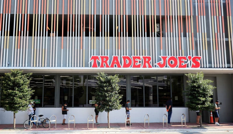 Customers wait in line to enter the Trader Joe's store in South Beach on April 14, 2020 in Miami Beach, Florida.