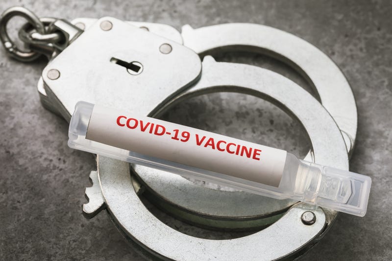 COVID-19 vaccine and handcuffs