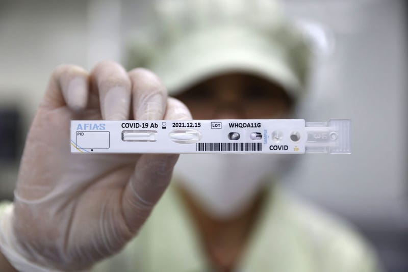  An employee holds up an AFIAS Covid-19 Ab testing kit used in diagnosing the coronavirus (COVID-19) at the Boditech Med Inc. headquarters on April 17, 2020 in Chuncheon, South Korea.