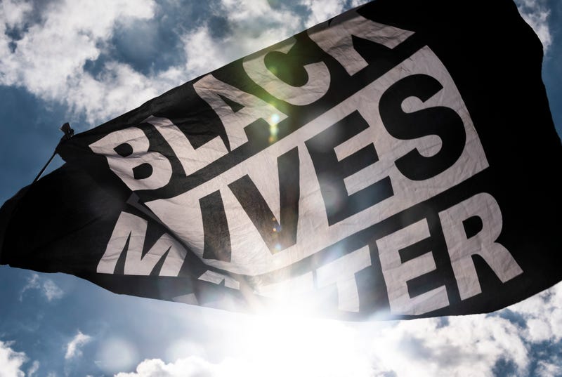 A Black Lives Matter flag waves during a demonstration.