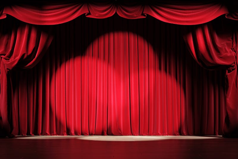 Theater stage with curtains drawn.