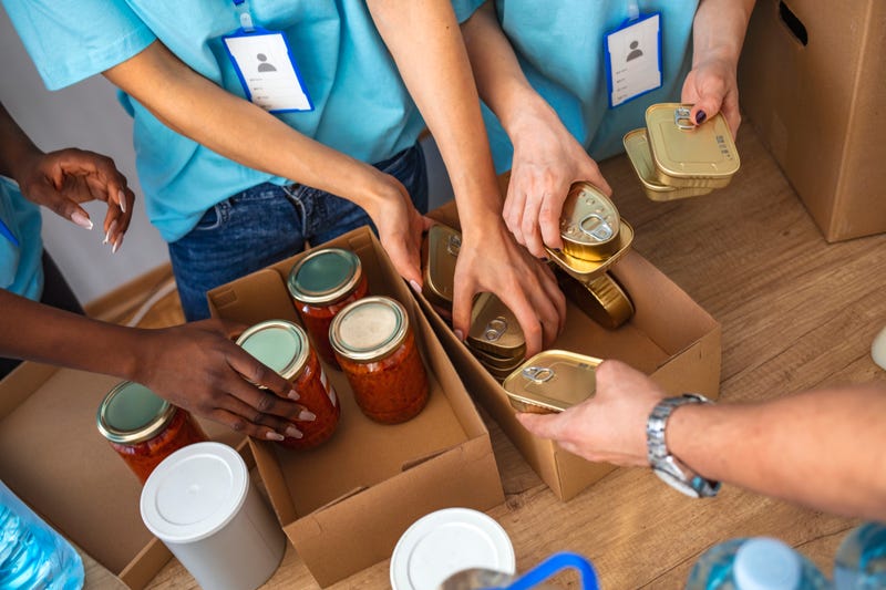Cardboard boxes being filled with food donations