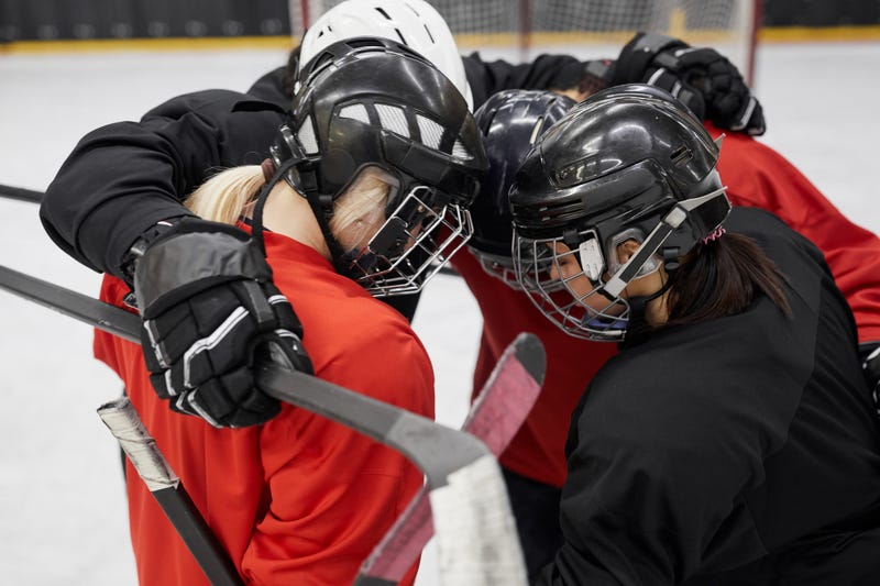 Women playing hockey