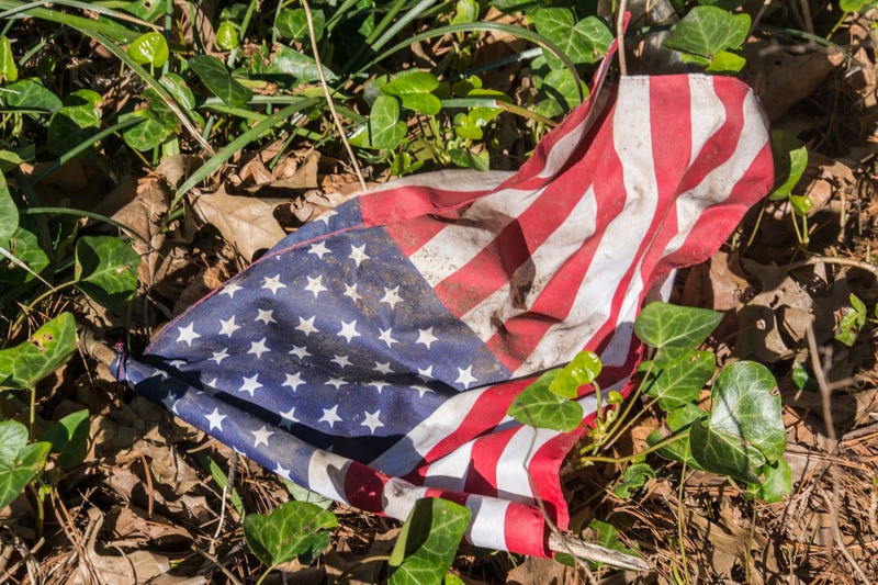 An American Flag can be seen on the ground.