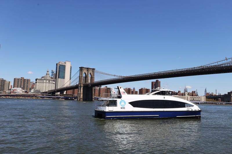 A NYC Ferry crosses the East River at Brooklyn Bridge Park on April 28, 2020
