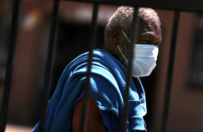 A homeless man wears a protective mask that he received in a health care package from the 100 Black Men of the Bay Area at Greater St Paul Baptist Church on April 28, 2020 in Oakland, California.