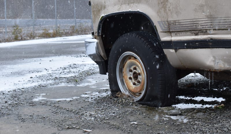 Flat tire on truck in snow