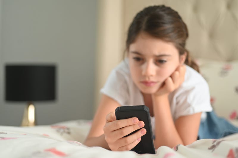 young girl using phone