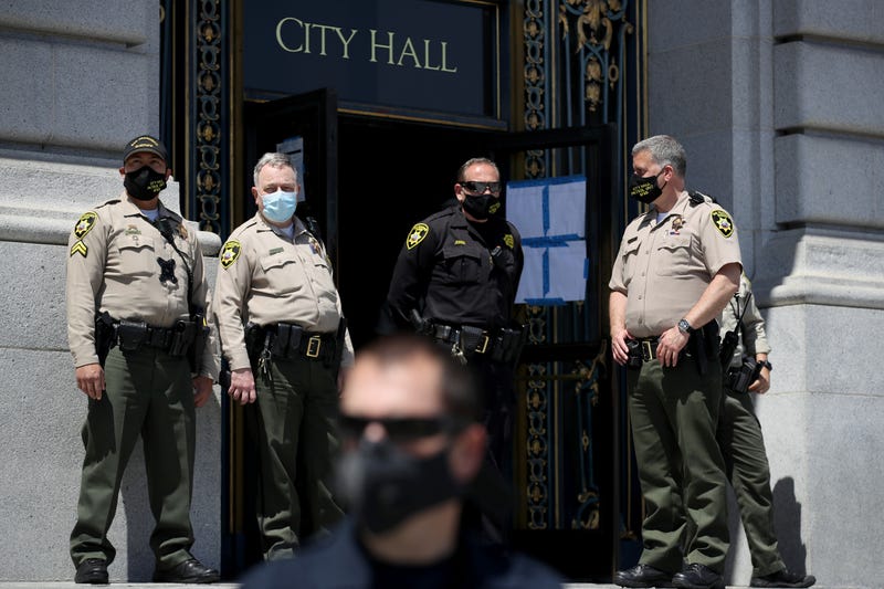 San Francisco sherrif deputies monitor a protest against California Gov. Gavin Newsom's continued statewide shelter in place order outside of San Francisco City Hall on May 01, 2020 in San Francisco, California.