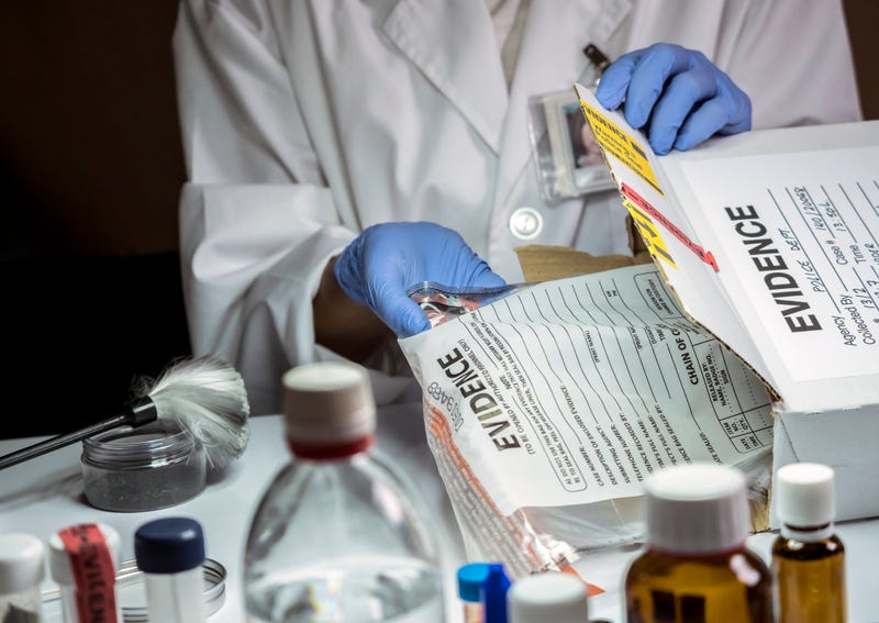 Forensic scientist working in a crime lab. 