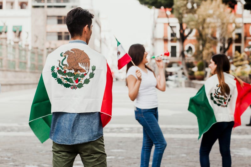 Mexican people cheering with flag of Mexico