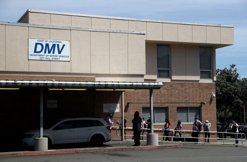 People wait in line to enter a California Department of Motor Vehicles (DMV) office on May 08, 2020 in San Francisco, California.