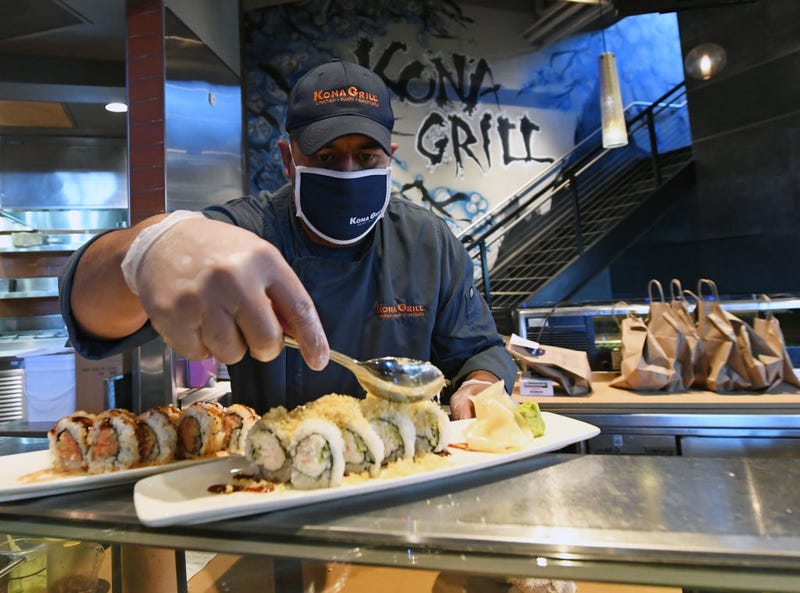 Sushi chef Juan Hernandez prepares food at Kona Grill in Boca Park Fashion Village as some businesses that were closed seven weeks ago to fight the spread of the coronavirus are allowed to reopen on May 9, 2020 in Las Vegas, Nevada.