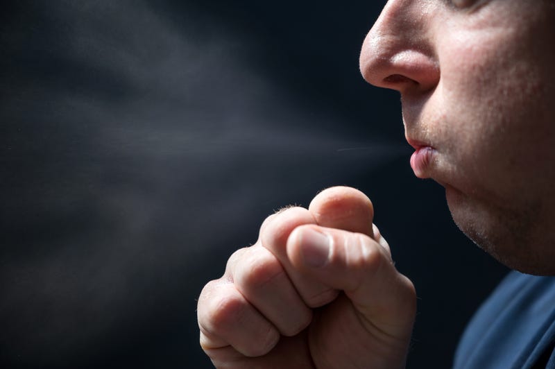 man coughing