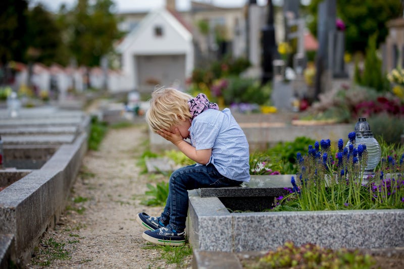 Child in cemetery stock photo.