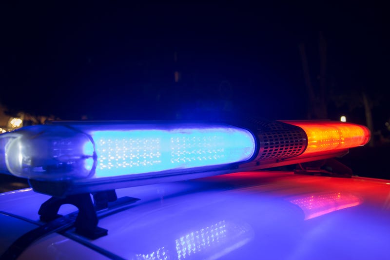 Roof of police car at night, lights flashing