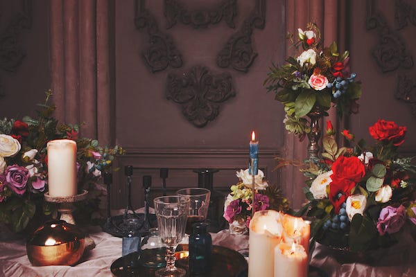 Table for a festive gala dinner, dark romance, Gothic style. Table setting with candles