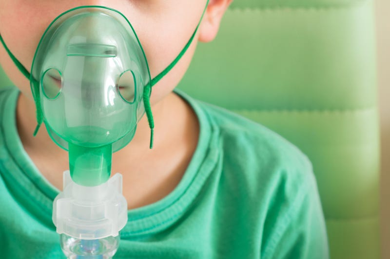 Child wearing oxygen mask