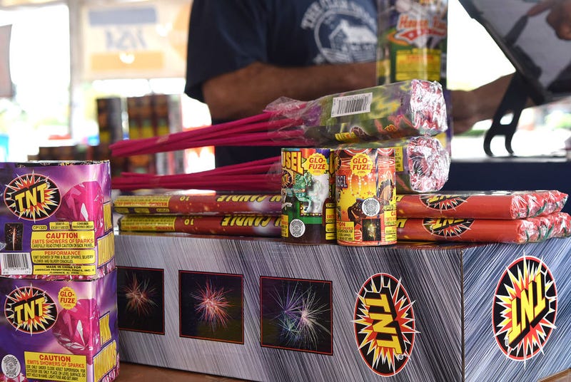 A customer purchases fireworks from a vendor in a temporary tent to celebrate Independence Day on July 4, 2020 in Orlando, Florida.
