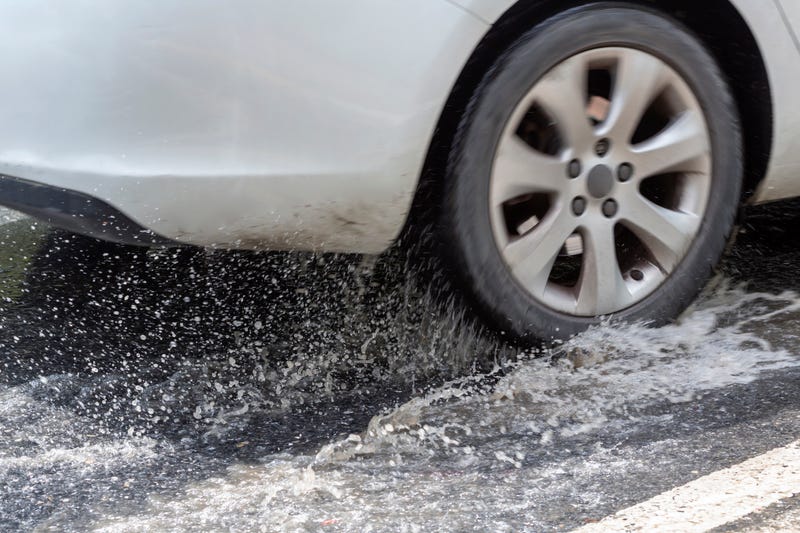 car wheel driving through puddle