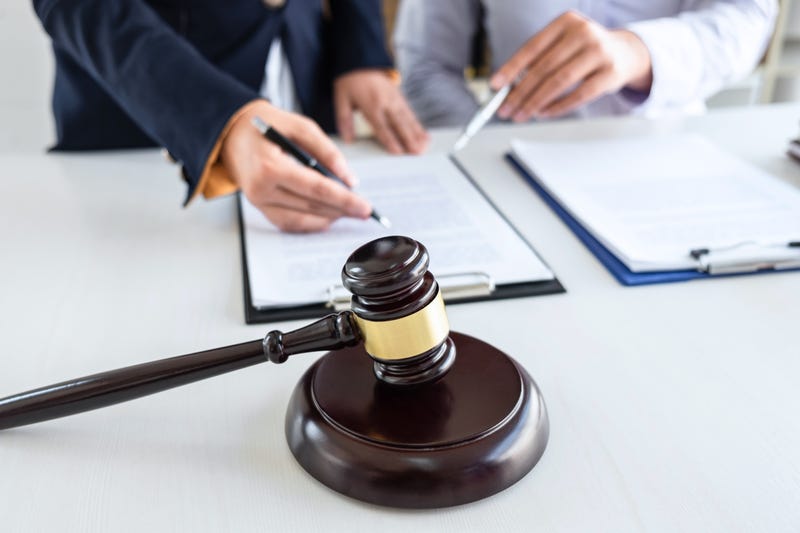 Professional female lawyer or counselor discussing negotiation legal case with client meeting with document contract in office, law and justice, attorney, lawsuit concept.