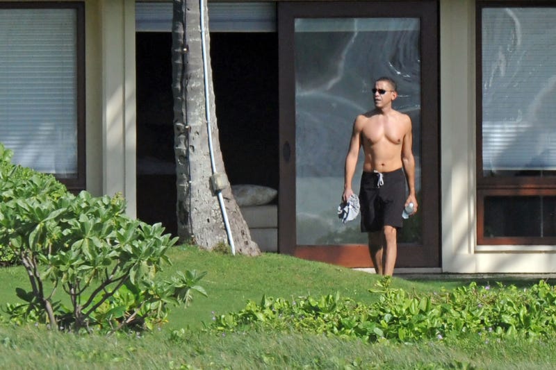 A shirtless Barack Obama is seen as he vacations with his family at a beachside compound on December 21, 2008 in Kailua, Hawaii.