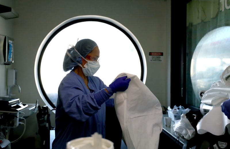 A nurse cleans personal protective equipment (PPE) after being part of a team that performed a procedure on a coronavirus COVID-19 patient in the intensive care unit (I.C.U.) at Regional Medical Center on May 21, 2020 in San Jose, California. 