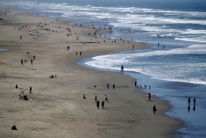People walk along Ocean Beach on May 26, 2020 in San Francisco, California.