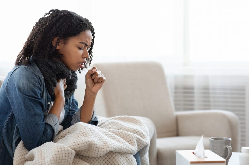 Woman sick with COVID-19 stock photo. 