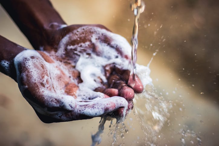 Person washing their hands.