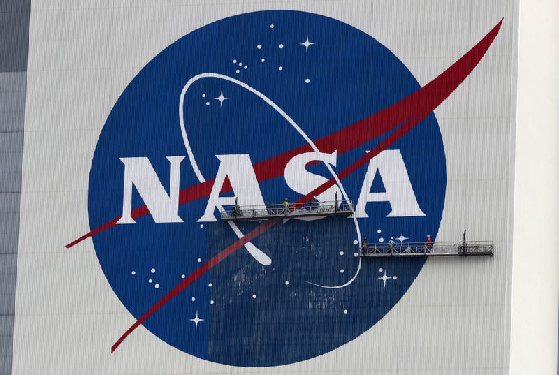 Workers repaint the NASA logo on the Vehicle Assembly Building at the Kennedy Space Center on May 28, 2020 in Cape Canaveral, Florida