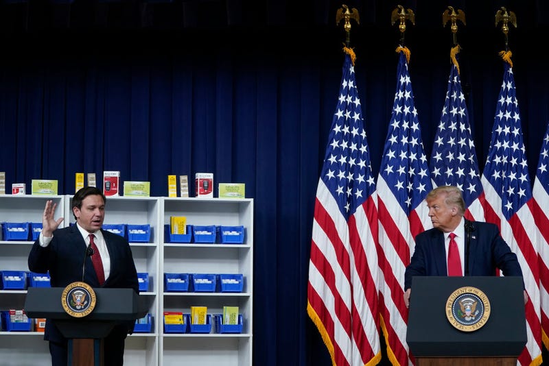 (L-R) Florida Governor Ron DeSantis speaks before U.S. President Donald Trump signs executive orders on prescription drug prices in the South Court Auditorium at the White House on July 24, 2020 in Washington, DC. 